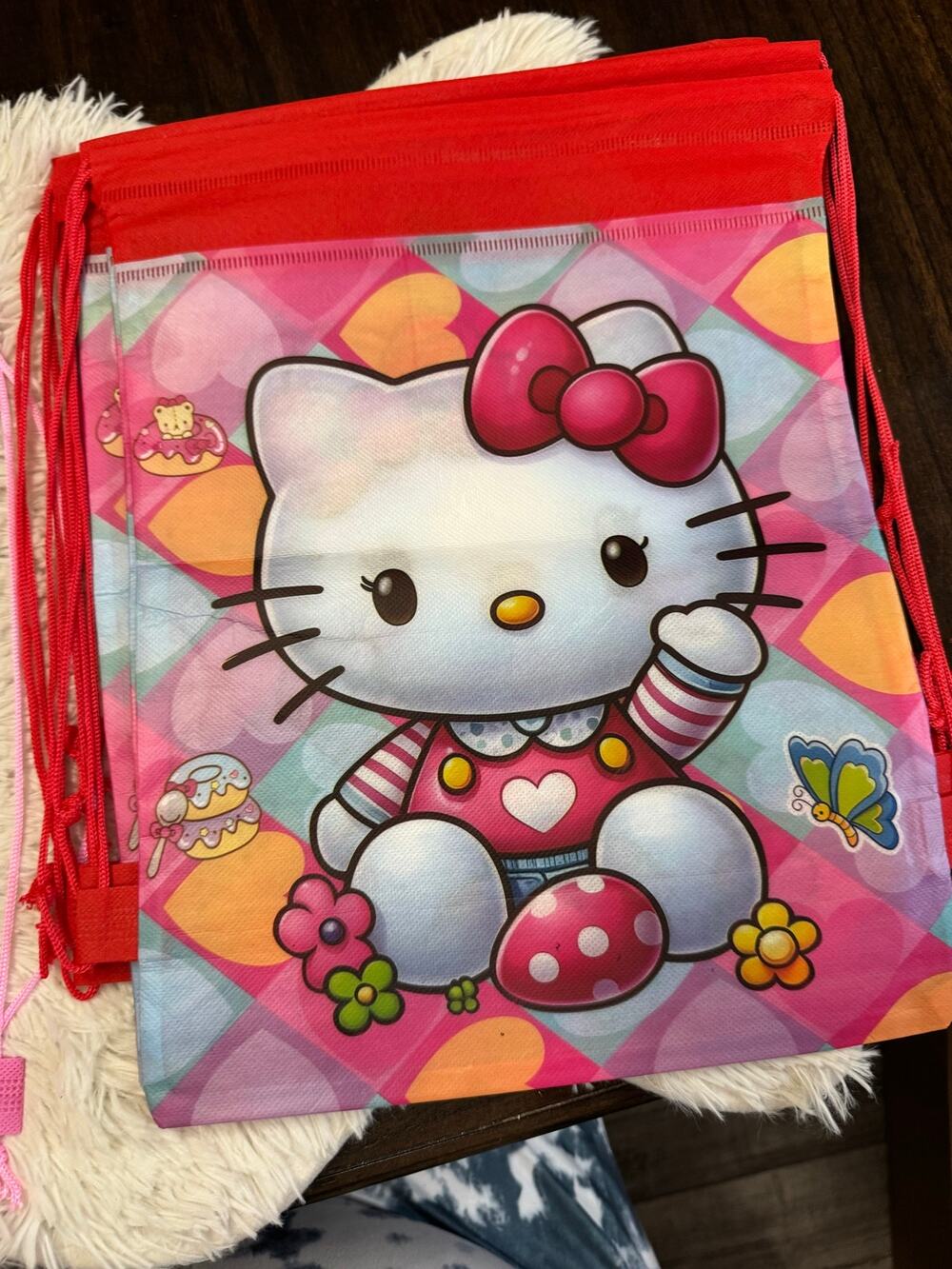 Hello Kitty red drawstring bag with Hello Kitty graphic, pink bow, and flowers